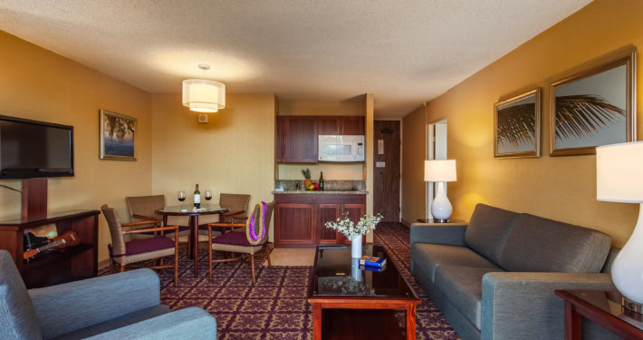 Hilo Hawaiian Hotel 1 bedroom Banyan view room with separate seating, kitchenette and a dining area