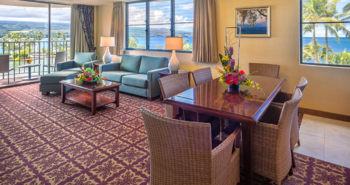 Hilo Hawaiian Hotel 1 bedroom ocean view room with dining table and separate seating area near balcony