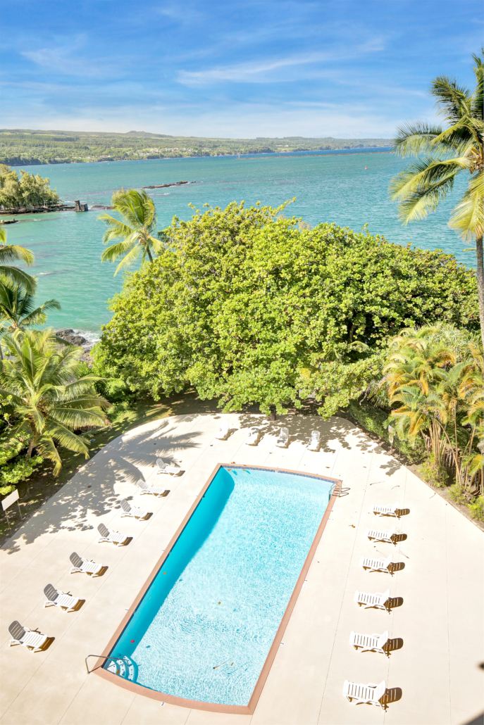 Hilo Hawaiian Hotel - pool with lounge chairs on a sunny day